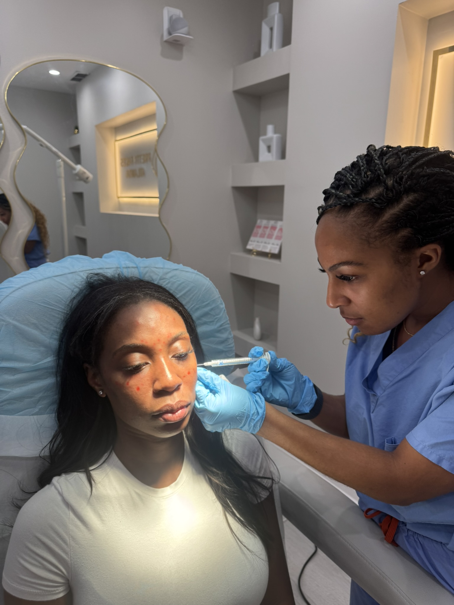 Botox injection with treatment points mapped across the forehead and cheeks during a wrinkle treatment at OMI Aesthetics in Smyrna, Georgia