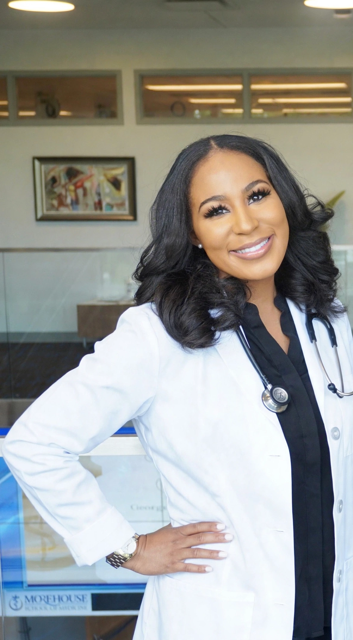 Dr. Nina Wyatt, MD MS in a white coat and stethoscope, founder of OMI Aesthetics, anti-aging and regenerative medicine physician in Smyrna, Georgia