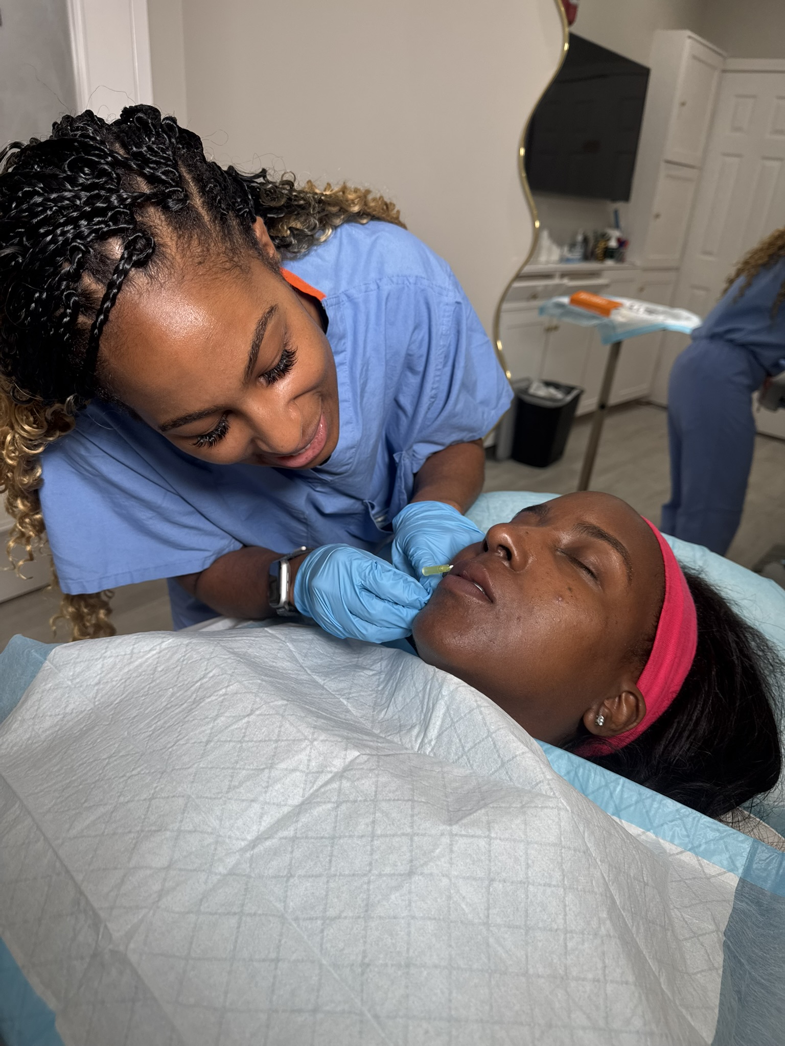 Hyaluronic acid lip filler being injected during a dermal filler treatment at OMI Aesthetics in Smyrna, Georgia